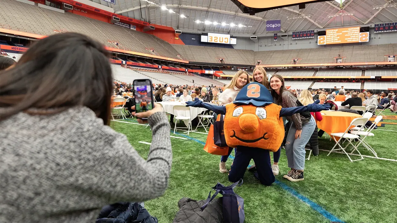 Admitted students posing for a photo with Otto.